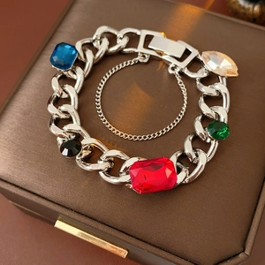 Macro detail of silver link bracelet featuring five vibrant large multicolor gemstones