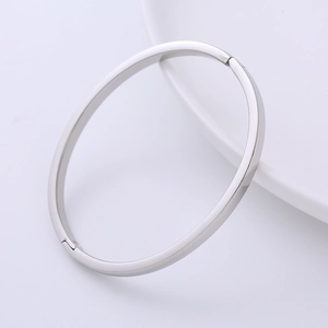 Detailed macro view of the silver polished stainless steel bangle with clasp closure