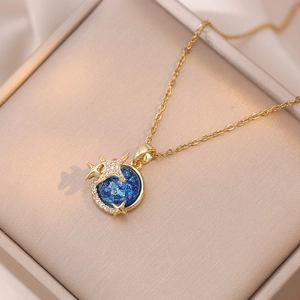 Elegant gold celestial necklace with blue nebula pendant and zircon stars in a gift box