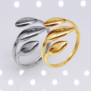 Detail of silver and gold adjustable leaf rings with polished stainless steel finish