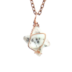 Macro detail of handmade wire wrapped stone pendant with antique bronze chain