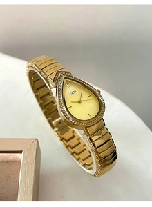 Detail of luxury teardrop quartz watch with gold metal band and diamond accents