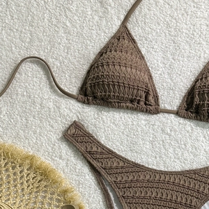 Detail of chocolate brown smocked bikini showing high-elastic textured fabric and stitching