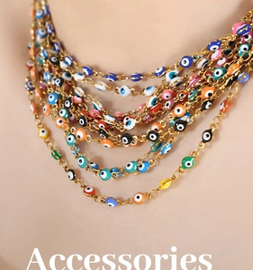 Detail of layered gold chain necklace featuring colorful enamel evil eye charms