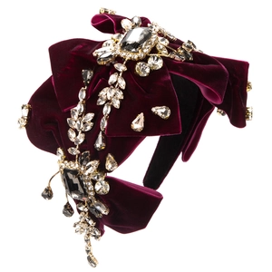 Macro shot of luxury burgundy velvet headband with crystal bows and rhinestones