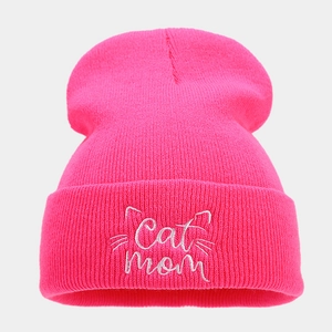 Detail of neon pink cat mom embroidery on ribbed knit beanie cuff for winter