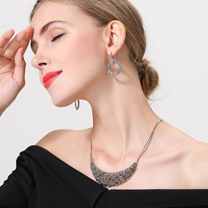 Elegant silver hoop earrings and bib necklace set with sparkling black crystals