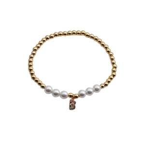 Close-up of golden beaded bracelet with white pearls and zircon encrusted letter B charm