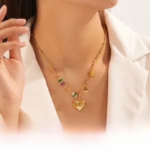 Detail of gold-plated stainless steel heart necklace with rhinestones and colorful beads