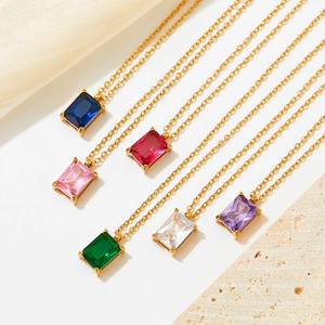 Macro shot of colorful zircon rectangular pendants on golden stainless steel necklaces
