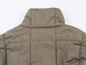 Detailed macro view of the khaki quilted fabric and stand collar on the back of the jacket