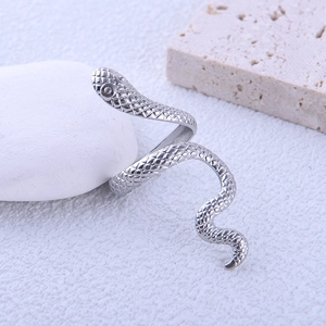 Close-up of adjustable snake-shaped stainless steel ring with detailed scale texture