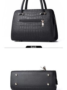 Detail of crocodile pattern handbag with back zipper and bottom protective metal rivets