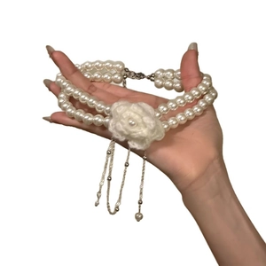 Elegant double-layered pearl necklace with knitted flower and metallic tassel pendant