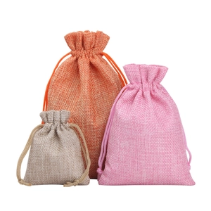 Linen drawstring jewelry pouches in orange, pink, and grey with multiple size options