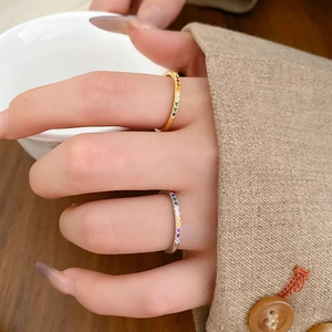 Detail of elegant gold and silver rings with vibrant rainbow cubic zirconia gemstones
