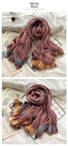 Detail view of burgundy striped wool scarf with raw edges and bohemian tassel fringe