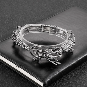 Detailed view of punk dragon scale bracelet with intricately carved silver dragon head