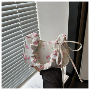 Floral print shoulder bag with ruched strap and pink roses on white fabric detail