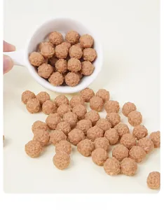 Close-up of realistic miniature meatballs with detailed texture in a white ceramic spoon