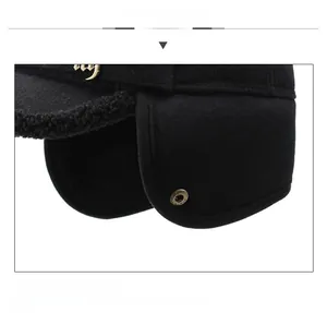 Detail display of black wool baseball cap with folding earflaps and thick fleece lining