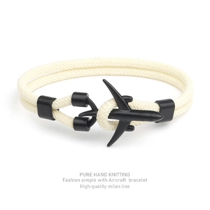 Close-up of beige hand-knitted Milan rope bracelet with a black aircraft buckle