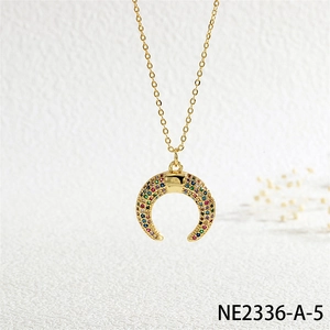 Close-up of crescent horn necklace with colorful micro-inlaid stones and gold chain