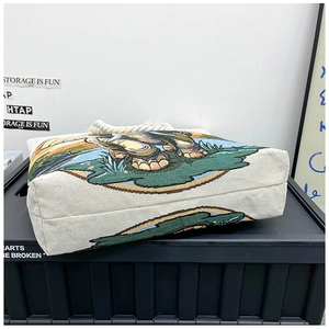Detail showing reinforced base and stitching of embroidered elephant canvas tote bag