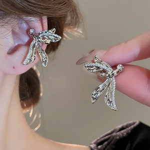 Detailed view of silver plated dragonfly ear cuff with shimmering cubic zirconia wings