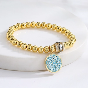 Elegant 18K gold plated beaded bracelet with blue enamel evil eye charm and zircon clasp