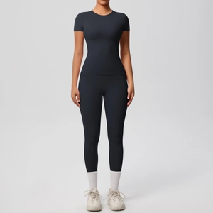 Slim fit black yoga set featuring a breathable short sleeve top and high-stretch leggings