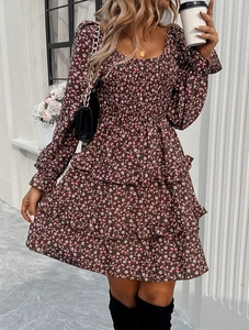 Detail of square neck floral dress with puff sleeves and layered ruffle hemline