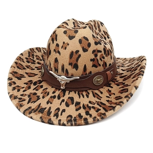 Detailed close-up of leopard print cowboy hat with vintage silver bull head metal ornament
