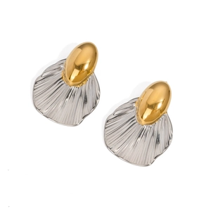 Detail of two-tone gold and silver earrings with textured shell-inspired metal plates