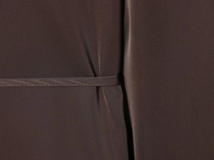 Detailed close-up of dark brown poplin shirt fabric featuring fine stitching and texture