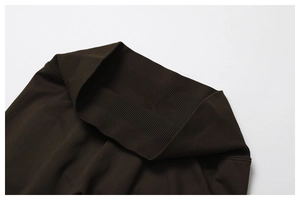 Detail of high-waisted ribbed knit on dark brown seamless yoga pants for core support