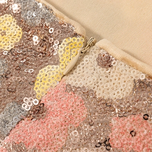Macro detail of multi-color sequin fabric with high-quality invisible zipper closure