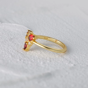 Close-up of S925 sterling silver ring with red heart gemstone and triangular zircon inlay
