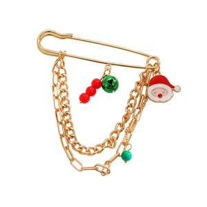 Detailed view of Christmas Santa Claus brooch with golden chains and festive charms