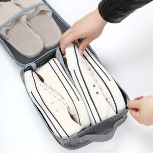 Three-layer travel shoe organizer bag in grey oxford fabric with luggage handle strap