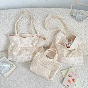 Detailed set of white lace crochet tote bags with elegant ruffles on a soft white background