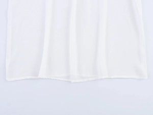 Detail of white chiffon shirt hem showing fine stitching and lightweight texture
