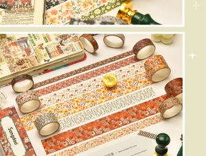 Detailed view of floral washi tapes arranged with vintage journals and wax seals