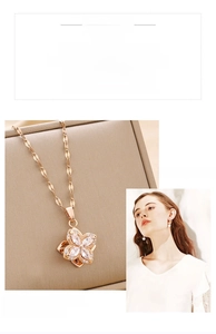 Close-up of titanium steel four-leaf clover pendant necklace with clear zircon stones