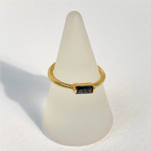 Macro shot of S925 silver gold ring with rectangle black stone and twisted band