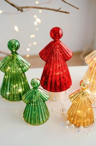 Close-up of glowing glass angel ornaments in red, green, and gold with LED light effect