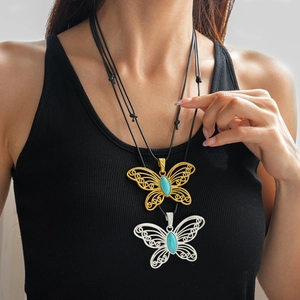 Detail view of hollow butterfly pendant with turquoise stone on adjustable wax rope necklace