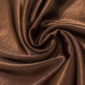Brown bohemian satin maxi skirt with glossy finish and elegant lace patchwork detailing