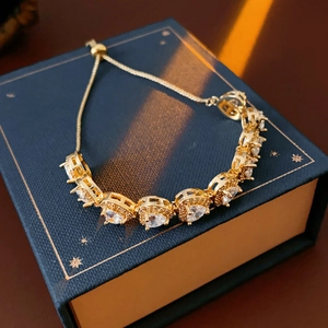 Detailed view of heart-shaped zircon bracelet with adjustable bolo closure on a jewelry box