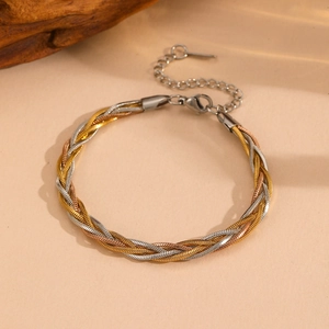 Close-up of woven snake chain bracelet in gold, silver, and rose gold finishes